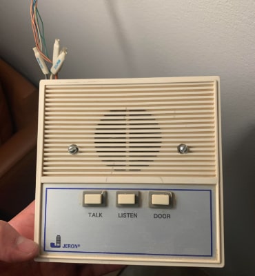 Vintage apartment intercom panel with TALK, LISTEN, and DOOR buttons